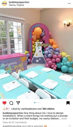 the table is set up with balloons and other decorations