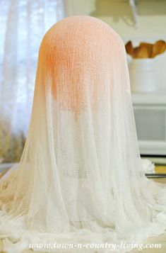 an orange and white hat sitting on top of a table next to a microwave oven