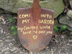 a rusty garden shovel with writing on it