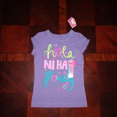 Brand New Never Worn Girl's T-Shirt. Says Hello In Three Different Languages. Really Cute Shirt Playful Purple Cotton T-shirt, Cute Purple Top With Letter Print, Playful Purple Cotton Tops, Cute Purple Top With Graphic Print, Fun Purple Short Sleeve Tops, Fun Short Sleeve Purple Tops, Cute Purple Shirt With Graphic Print, Cute Purple Short Sleeve Shirt, Fun Purple Cotton Tops