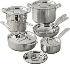 an assortment of pots and pans with lids