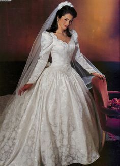 a woman in a white wedding dress and veil