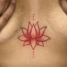 a woman's breast with a flower tattoo on it