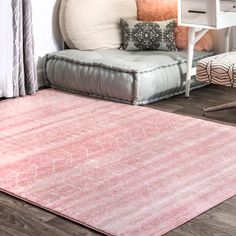 a living room area with a couch, chair and rug