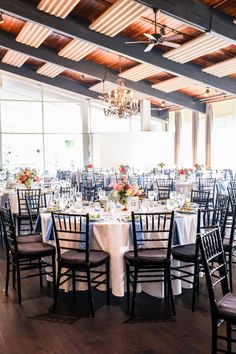 Image of the wedding reception space at the Cape Club of Sharon, a wedding venue in Massachusetts. The photo features the tables in the reception space with pastel Wedding Flower Centerpieces at the Cape Club of Sharon

Photo by Ali B Photography Flower Centerpieces Wedding, Pastel Wedding, Flower Centerpieces