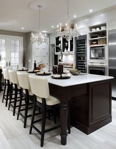 a large kitchen with an island in the middle and lots of counter space on one side