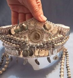 An Armenian taraz cannot be complete without a proper headdress. Often, even if the dresses themselves were rather plain, what women wore on their heads presented their social and financial status to the world around them. Make your wedding extra special with this gorgeous custom headpiece, tiara style, with hanging silver colored beads on the sides and our own Tigran Medz Coins on the forehead. These were traditionally used to ward off evil and will keep jealous eyes at bay on your very special Traditional Headpiece, Armenian Headdress, Armenian Wedding Traditions, Armenian Wedding Dress, Armenian Jewelry, Silver Wedding Headpiece, Silver Coin Jewelry, Armenian Wedding, Bohemian Headpiece