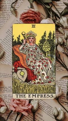 a tarot card sitting on top of an open book