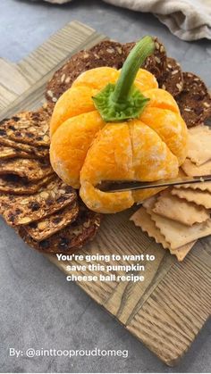 an orange sitting on top of some crackers