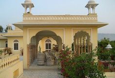 a yellow building with white trim and arches