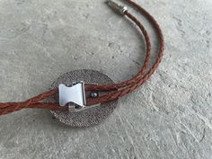 This awesome bolo tie has a southwestern design and agate centerpiece. The cord is genuine brown leather.Our bolos pair nicely with many of our belt buckles! They make wonderful gifts. The western bolo tie rope length is 39'' ; charm agate stone pendant size is 2'' x 1 1 /2'' Western Bolo Tie, Mens Leather Necklace, Southwestern Design, Tie Gifts, Bolo Tie, Men's Necklace, Stone Pendant, Agate Stone, Stone Pendants