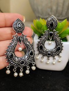 Add charm and charisma to your beautiful personality with these exquisitely designed and handcrafted stone studded earrings in high quality German Silver.Pair them up with any semi or casual attire and win compliments for your unique choice!Weight 16 gms Length 2.7"Width 1"****************************************Note: All in stock items will be shipped from New Delhi, India within 2-3 business days after receipt of payment. International orders may take anytime between 3 to 5weeks for your shipm Gift Stone Work Pearl Drop Earrings, Gift Pearl Drop Earrings With Stone Work, Silver Pearl Earrings With Stone Work For Gift, Bohemian Stone Work Earrings For Gift, Temple Jewelry Stone Work Dangle Earrings, Bohemian Earrings With Stone Work For Gift, Traditional Crystal Earrings For Festive Occasions, Chandbali Earrings With Stone Work, Stone Work Drop Earrings For Gift