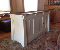 a bed frame in the middle of a living room