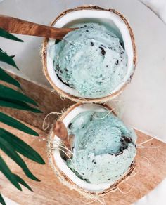 two coconut bowls filled with blue ice cream