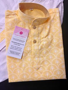 "Premium Quality Cotton Dhoti Sets for Infants and Boys. Very Soft and skin friendly. Item : Boys Kurta Pajama Ready to Wear : Yes Kurta Color : Light Yellow Dhoti Color : White Fabric : Cotton Lining : No Lining Pockets : Yes Disclaimer -For sizing please refer to the Size Chart given in the listing with the pictures. - Please do NOT go by the size of the Kurta that you already have from another maker. All makers have different size Charts. - Size mentioned in the Size chart is the \" Kurta mea Yellow Block Print Sets For Diwali, Yellow Cotton Block Print Sets, Cotton Block Print Sets For Puja, Yellow Bandhani Print Kurta For Summer, Fitted Yellow Block Print Kurta, Summer Yellow Bandhani Print Kurta, Yellow Cotton Kurta With Bandhani Print, Yellow Cotton Bandhani Print Set, Yellow Bandhani Print Cotton Set