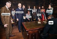 a group of people standing around a wooden table in a room with many words on it