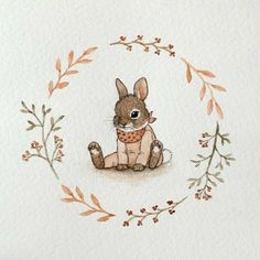 a watercolor drawing of a rabbit in a wreath