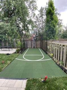 an outdoor basketball court in the backyard