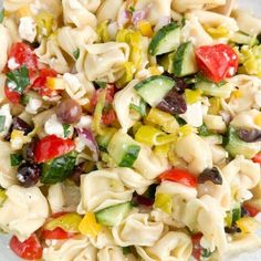 a pasta salad is shown in a white bowl