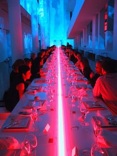 a long table with red and blue lights in the middle is seen on instagram