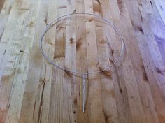 a wooden floor with a wire on top of it and an object in the middle