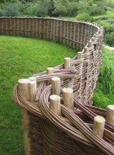 several wooden posts are lined up in the grass