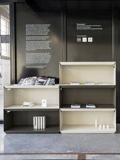 a display case with books and other items on the shelves in front of it,