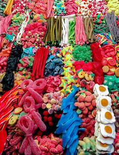 an assortment of food is displayed on a large display case at a market stall, including eggs, sausages, and other foods