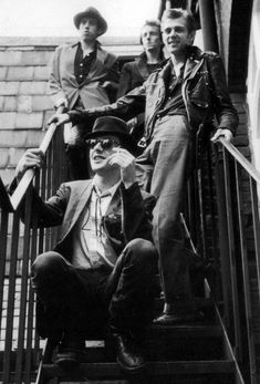 an old black and white photo of men on stairs