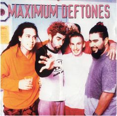 a group of young men standing next to each other in front of a sign that says maximum deftones