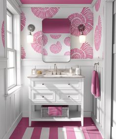 a bathroom with pink and white decor on the walls, floor, and vanity area