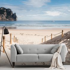 a couch sitting on top of a sandy beach