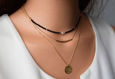 "*All components are 14 k Gold filled *Black spinel bead: 0.08\" (2 mm). *Length on model is 16 inches(40 cm). *At the back, there's a 2\" extender chain. Dainty Gold Necklace, Black spinel Necklace,Pearl and Black Bead Necklace,Layered Necklace, Gold Necklace, Gold Minimalist Necklace. Dainty Gold necklace and Black Spinel Beads. This simple yet elegant necklace looks great for layering with other delicate necklace or minimalist wear. simple and elegant necklace suitable for every day or evenin Minimalist Gold Beaded Necklace With Black Beads, Dainty Gold Necklace With Black Beads, Minimalist Black Spinel Necklace, Elegant Black Spinel Beaded Necklace, Gold Minimalist Necklace, Gold Multi-strand Necklace With Black Beads, Layered Necklace Gold, Spinel Necklace, Delicate Silver Necklace