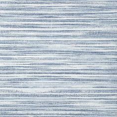 a blue and white rug with vertical stripes