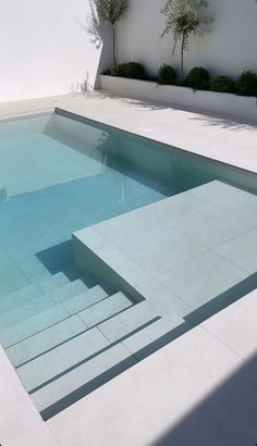 an empty swimming pool with steps leading up to it