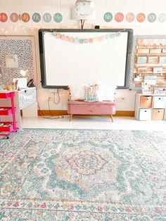 a living room with a large rug and lots of decorations on the wall behind it