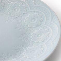 a blue plate with white designs on it