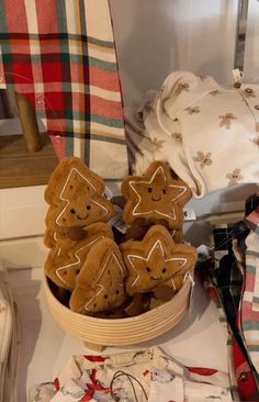 a basket filled with cookies sitting on top of a table next to folded towels and other items