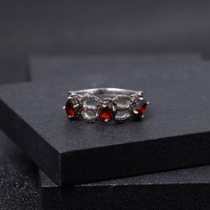 Experience the Timeless Beauty of Garnet Indulge in the elegance of our exquisite Red Garnet Three Stone Ring. This stunning piece is crafted from 925 Sterling Silver, showcasing a classic design that embodies grace and sophistication. The rich, deep hues of garnet are not just beautiful but are also known for their healing properties, promoting passion, energy, and vitality. Key Benefits of Our Garnet Ring: Emotional Healing: Garnet is revered for its ability to inspire love and devotion, makin Silver Gemstone Rings, Antique Style Rings, January Birthstone Rings, Three Stone Ring, Garnet Jewelry, Garnet Ring, Emerald Stone, Garnet Rings, Three Stone Rings