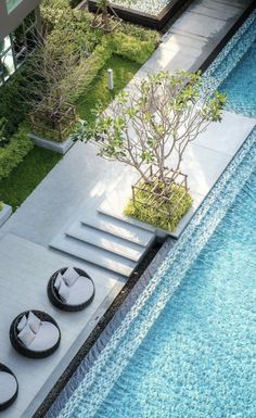 an aerial view of a pool with lounge chairs