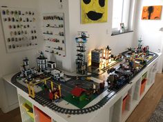 a toy train set is on display in a room with legos and other toys