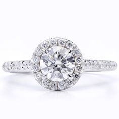 a white gold engagement ring with an oval cut diamond surrounded by pave set diamonds