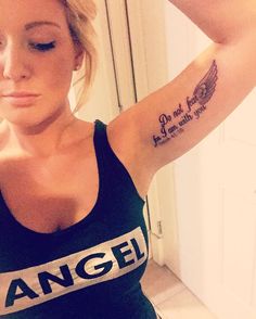 a woman with an angel tattoo on her arm