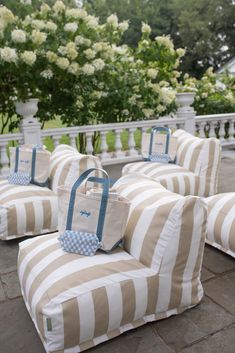 several striped couches with matching bags on them