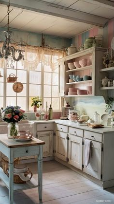 a kitchen filled with lots of white cabinets and counter top next to a table in front of a window