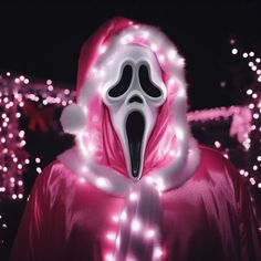 a person wearing a ghost mask with lights around it