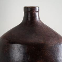 a brown vase sitting on top of a table