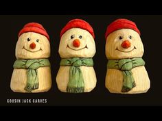 three wooden snowmen wearing hats and scarves