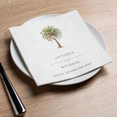 a white plate topped with a napkin next to a fork and knife on top of a wooden table