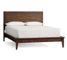 a bed with white sheets and wooden headboard on it's side, against a white background